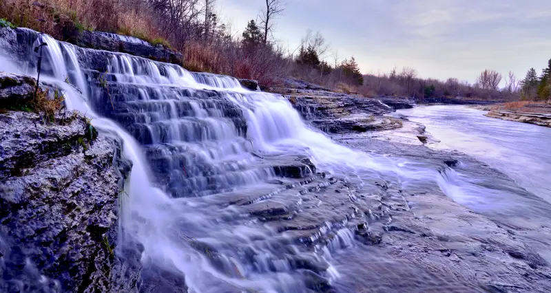 Water pouring over rock ledges on the Black River near Watertown