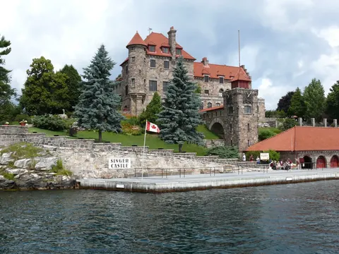 Singer Castle's stone towers and red roofs on Dark Island